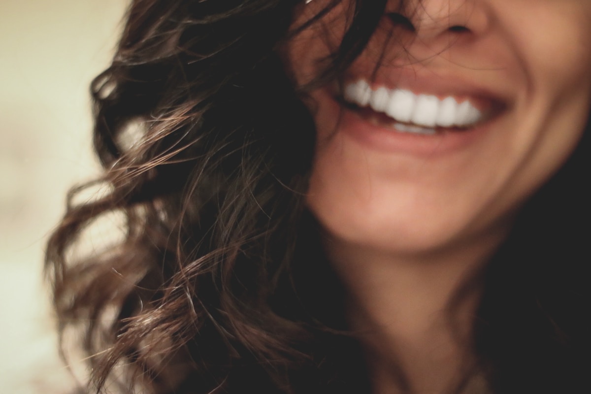 Photo by Lesly Juarez long black haired woman smiling close-up photography